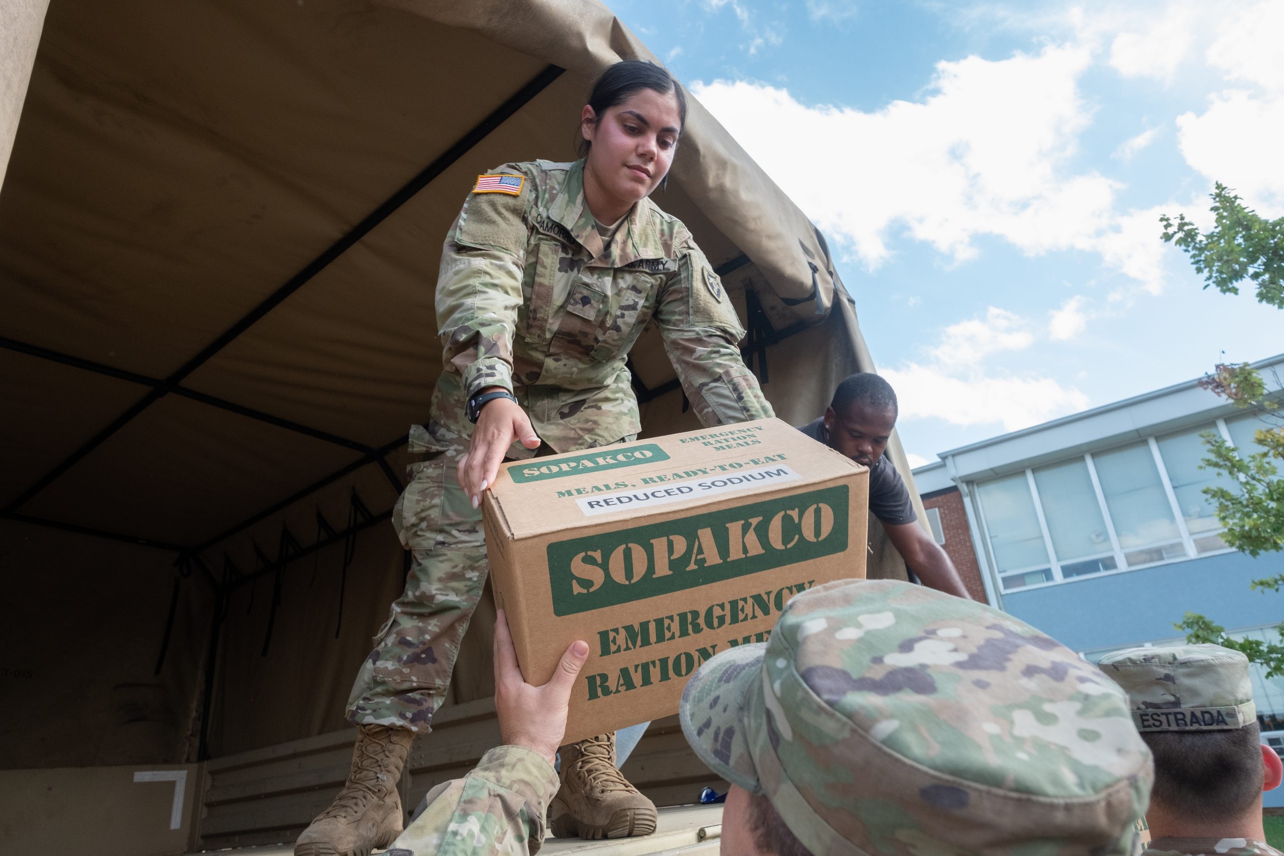 soldier handing supplies to soldier